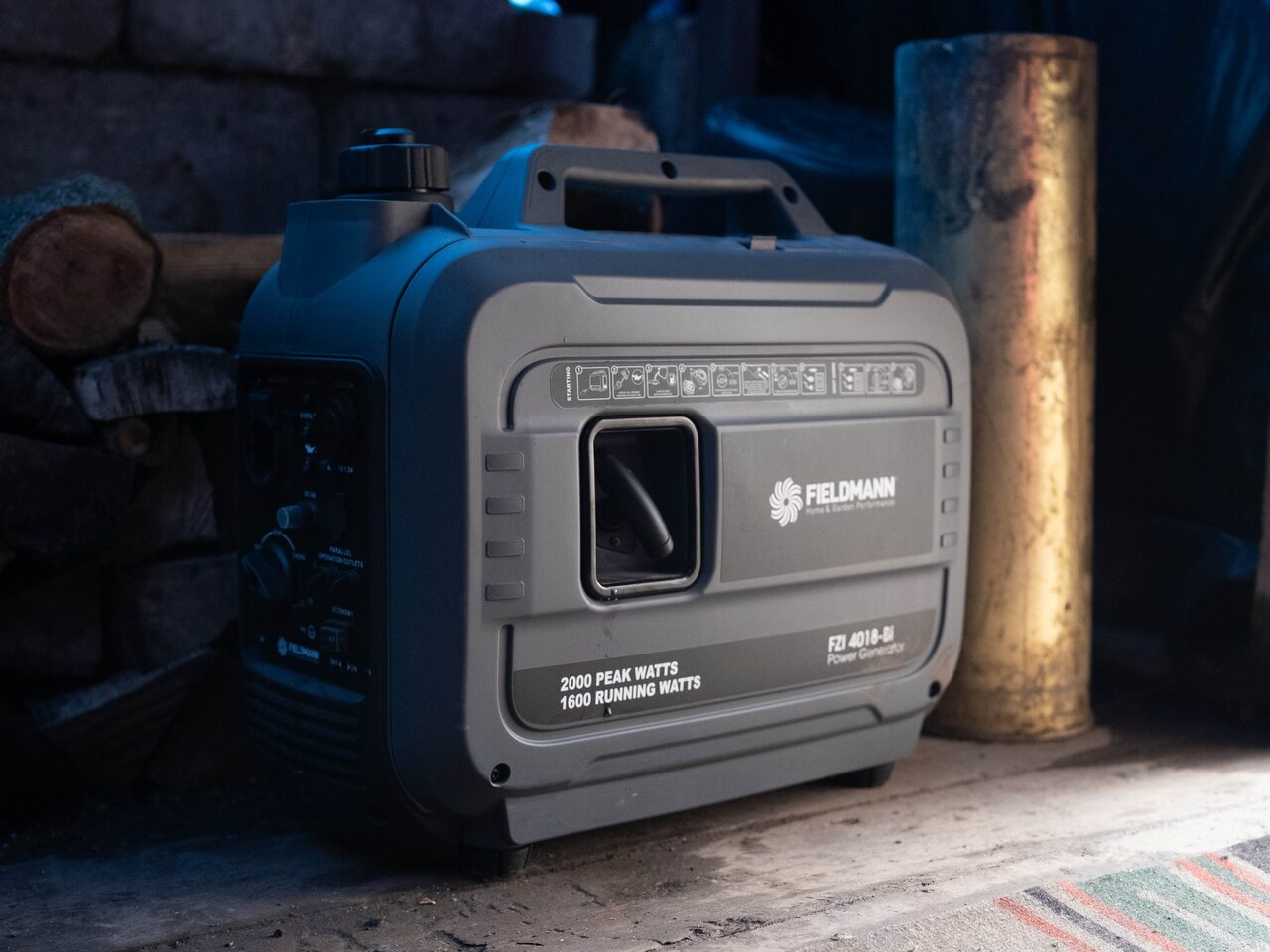 A 2,000-watt portable inverter generator deployed in a frontline shelter, beside a stack of firewood.